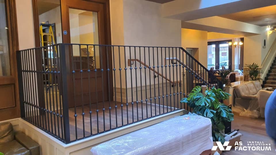 Landing balustrade with decorative metal balusters featuring knobs and a timber handrail