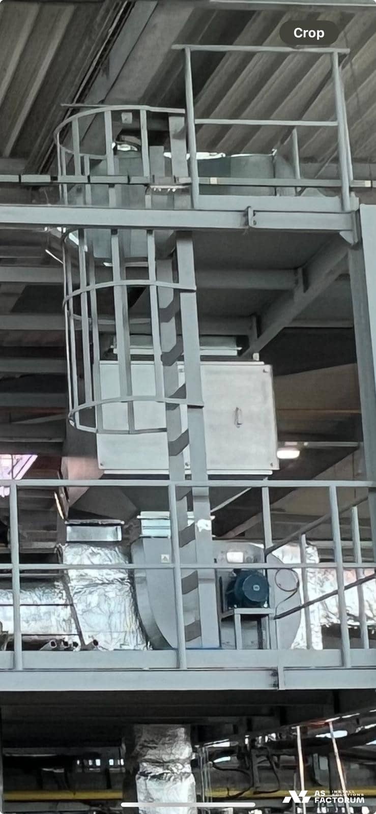 Railed steel platform with a caged ladder beside a fan and insulated ducts