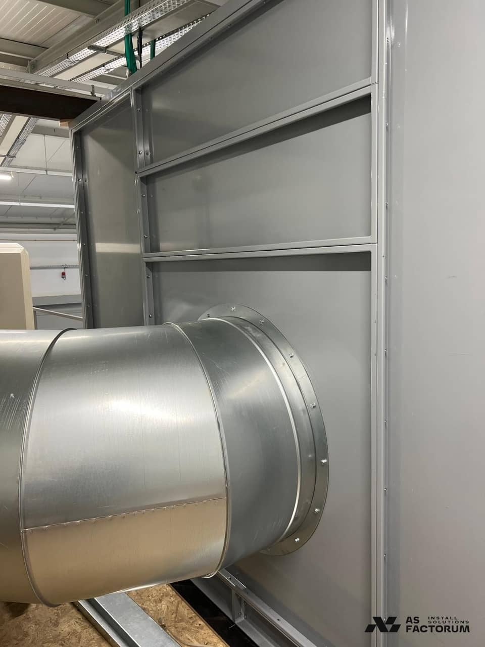 Grey unit enclosure with a flanged round galvanised duct