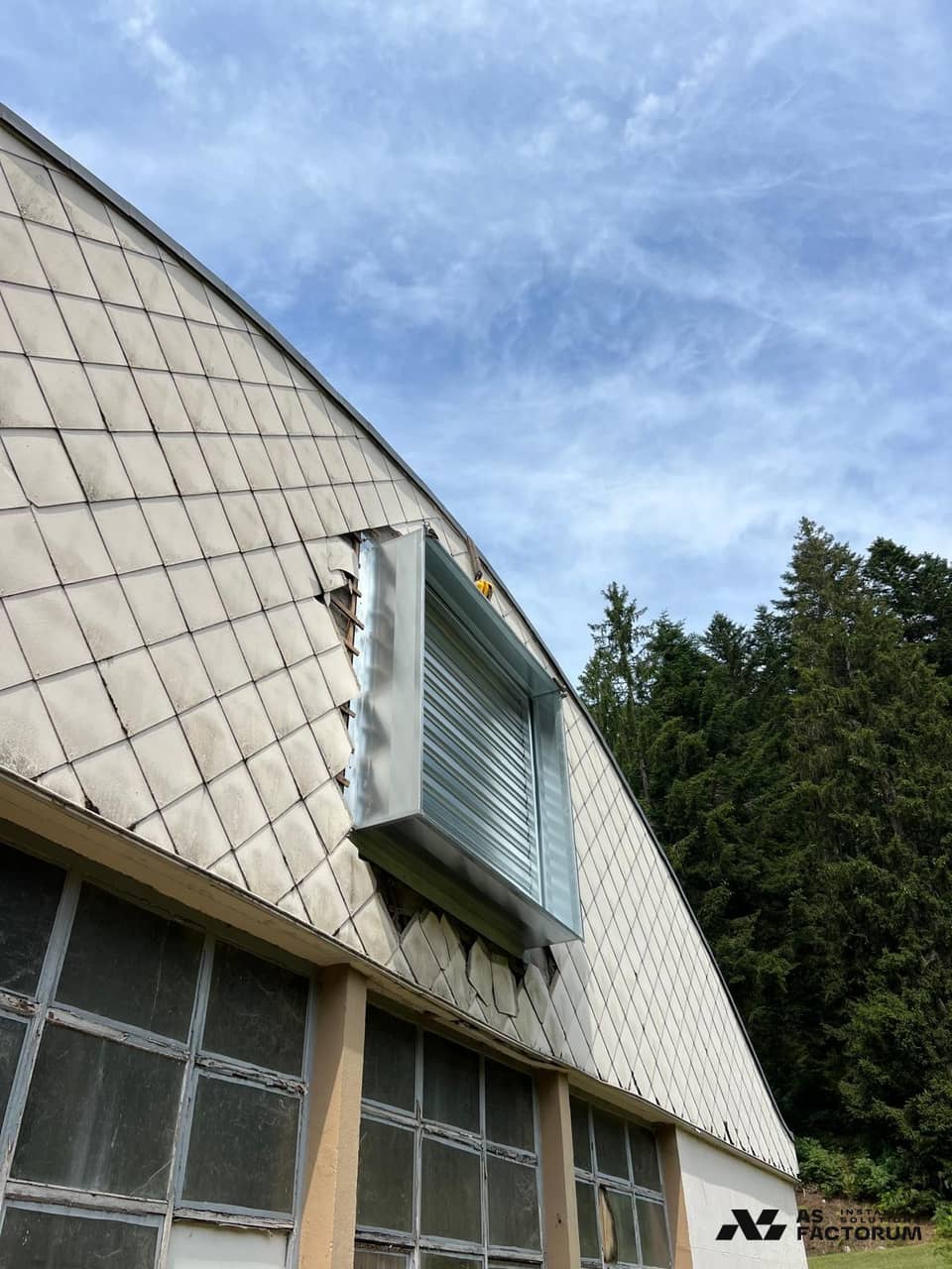 Louvred unit mounted on a curved, clad roof